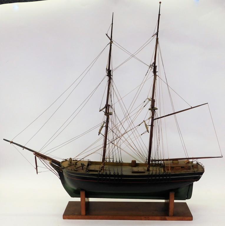 American Maritime Colonial Sailing Ship Model: United States,20th Century Scale model of a black and green sailing vessel with grand masts and intricate configuration of lines and wires. Wood,36 1/4" t x 40" w x 5 1/2" d, From the collection of a