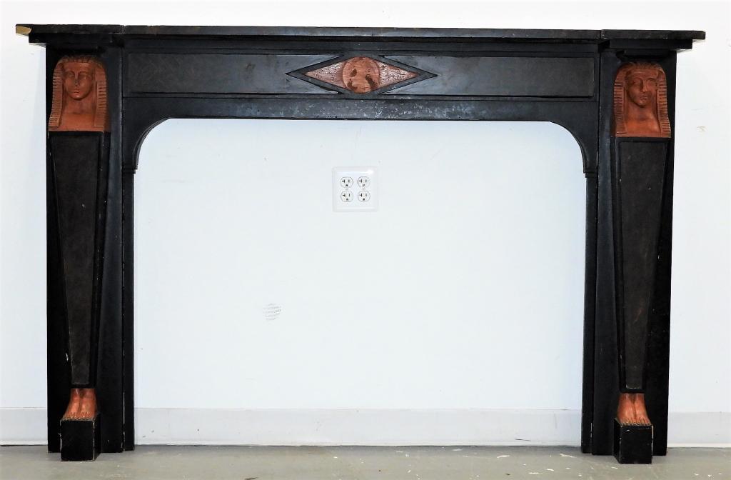 Egyptian Revival Carved Wood Art Deco Mantel: United States,Early 20th Century Black painted mantel with center diamond cartouche flanked by figural pharaoh's heads terminating into coffin form columns with carved feet with faux red marble painte