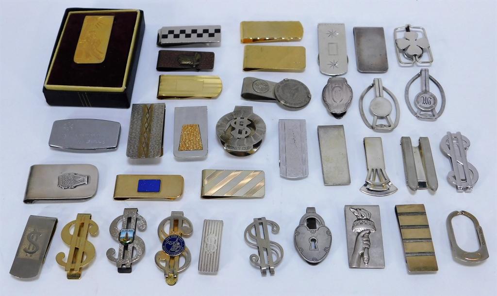 35PC Silver Tiffany & Co. Money Clip Collection: United States, Mexico,20th Century Includes one Christian Dior money clip, two Tiffany & Co. with one decorated with Lady Liberty's torch, two Simmons, one Zippo The Little Persuader clip, two Anson c