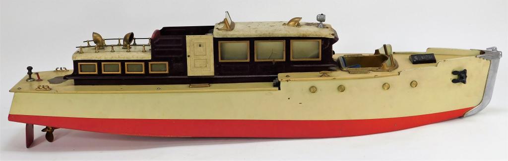 Orkin Craft Key Wind Cabin Cruiser Toy Yacht: United States,Early 20th Century Cream and red cabin cruiser with seat insert, rotating captains wheel, ball balance, and brass rotating propeller. Wood, tin,32" x 6 1/4", Labeled "Orkin Craft Scale M