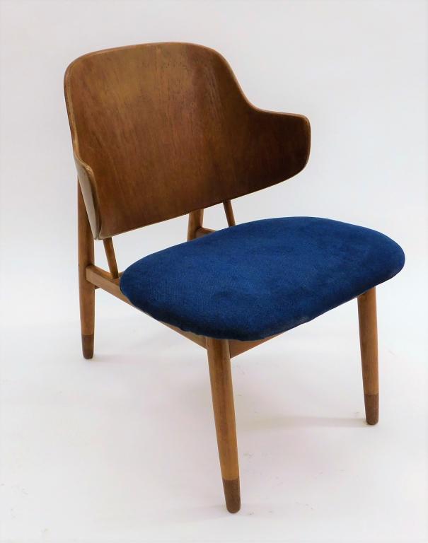 Ib Kofod-Larsen Danish MCM Penguin Chair: Denmark,Circa 1950 Shapely wing back chair with blue upholstered seat supported by four simple legs. Wood, fabric,29 1/2" t x 22" w x 25 1/2" d, Marked "Made in Denmark" on bottom. From the collection