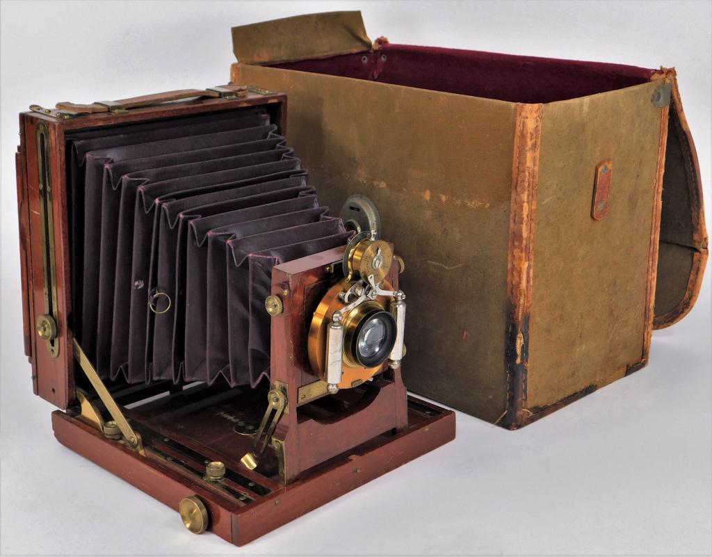 Unknown Early Wooden 5x7 Field Camera: Unknown early wooden 5x7 field camera with B&L iris diaphragm shutter, circa 1900. Flexible bellows. Includes vintage canvas case.