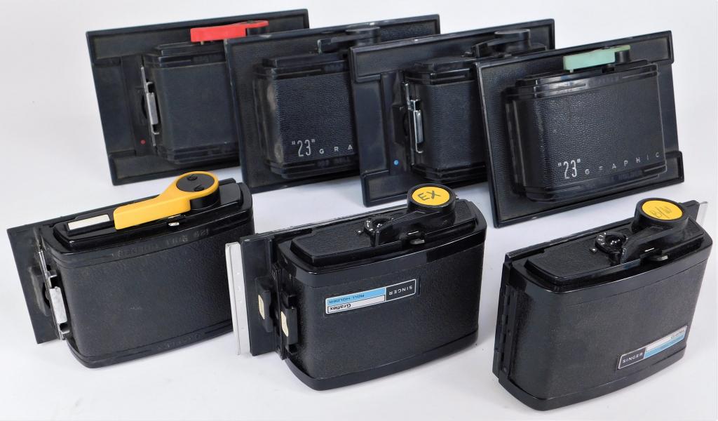Lot of 7 Graflex Lever Film Holder Backs: Lot of 7 Graflex lever rewind roll film holder backs.