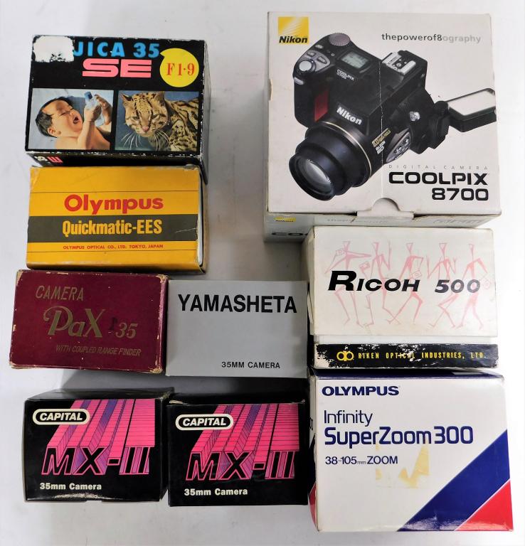 Group of 9 Japanese Cameras in Original Boxes: Group of 9 Japanese cameras in original boxes. Includes Nikon Coolpix, Ricoh 500, Olympus Infinity, Pax 35, Capital MX-II, Yamasheta, Fujica, and more as shown.