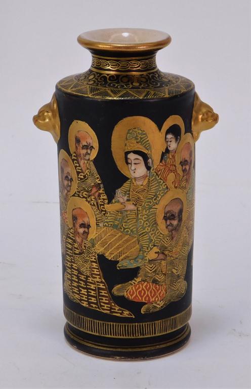 Japanese Meiji Gilt Black Satsuma Diminutive Vase: Japan,Meiji Period Cylindrical form with flared rim and figural beast handles decorated with a scrolling scene of the seven Immortals over a black ground. 5 1/8" x 2 1/8" dia., Underside with four cha