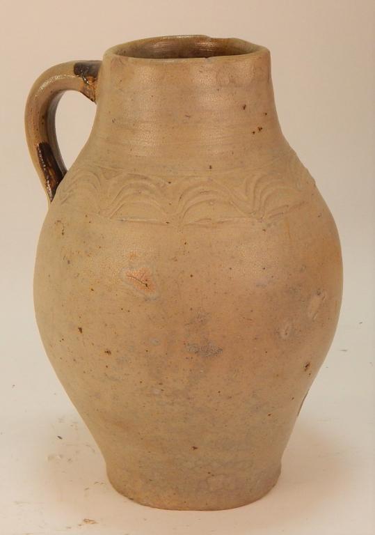 19C American Ovoid Stoneware Ewer Jug: ,United States,19th Century Ovoid form potted from grey earthenware with incised wave decoration around neck and scattered remanence of alkaline glaze primarily on handle. 11 3/4" tall,