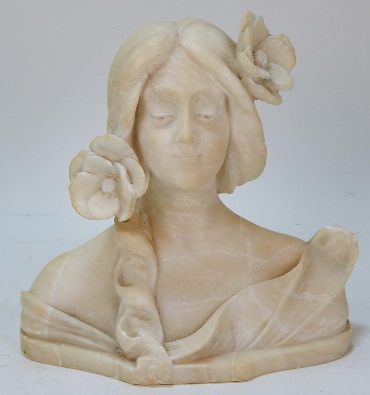 Art Nouveau Carved Alabaster Bust of Woman: ,Italy,Circa 1920 Serene looking young lady with flower in hair wearing an off the shoulder dress with long lock of hair on her chest. 8 1/2" x 9" x 4 1/2",