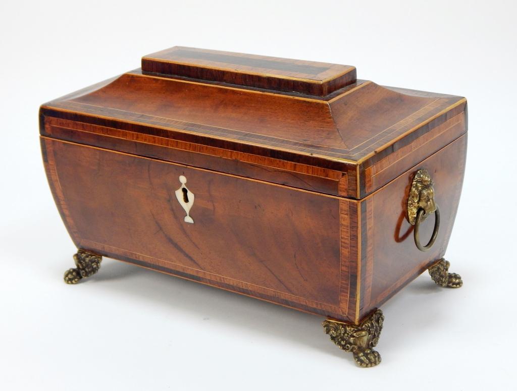 Antique Georgian Mahogany Inlaid Tea Caddy: ,England,Late 18th-19th Century Rectangular wooden box with tiered lid opening to a single compartment lined with yellow brocade, supported by decorative brass feet and lion head handles. 6 1/2" t x 9