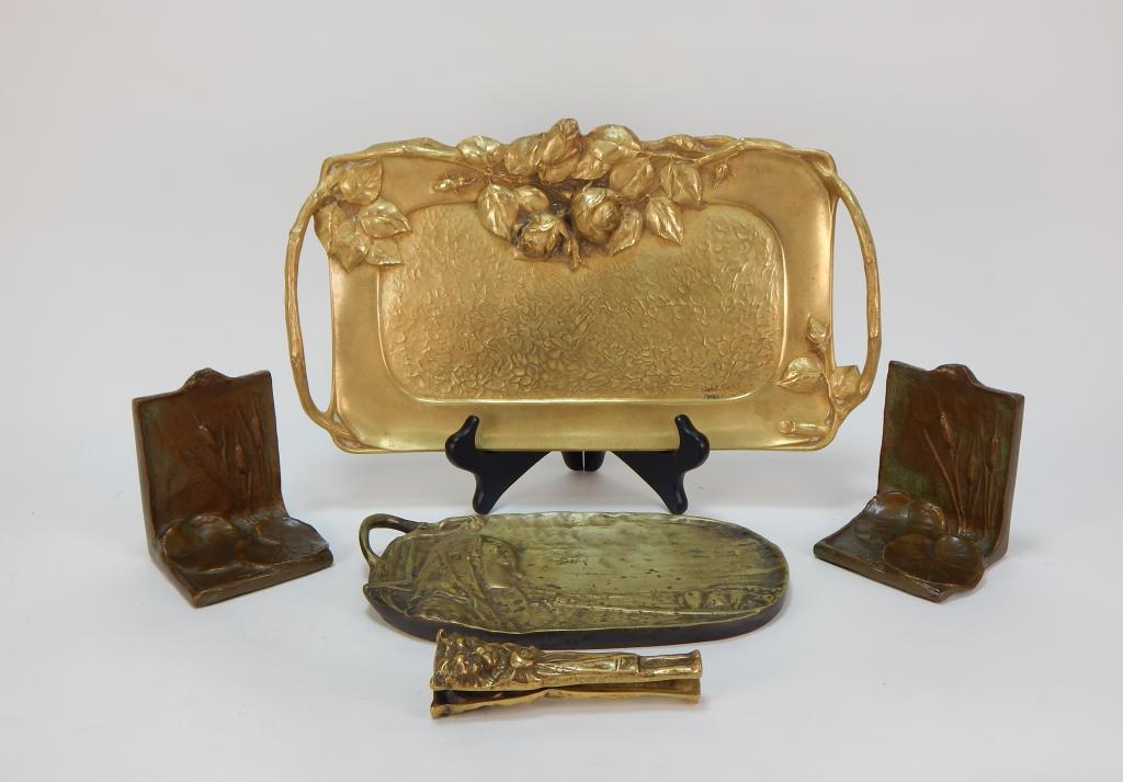 4PC Bronze Art Nouveau Pin Tray Bookends Group: ,United States, France,20th Century Includes a F. Claessens French dore tray decorated with roses and faux stem handles, a decorative tray depicting a young shepherd, figural cat nut cracker, and a pa