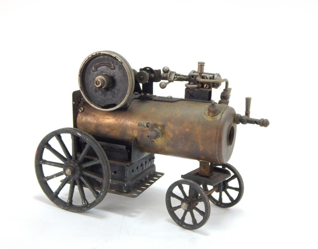 Attr. Marklin Steam Engine Tractor: ,Germany,19th Century Horizontal steam engine with light oxidation especially to wheels and some wear to engine components.8" t x 10 1/2" w x 5 1/2" d,,BrassMarked "Germany" with a "GM Cie" crest on s