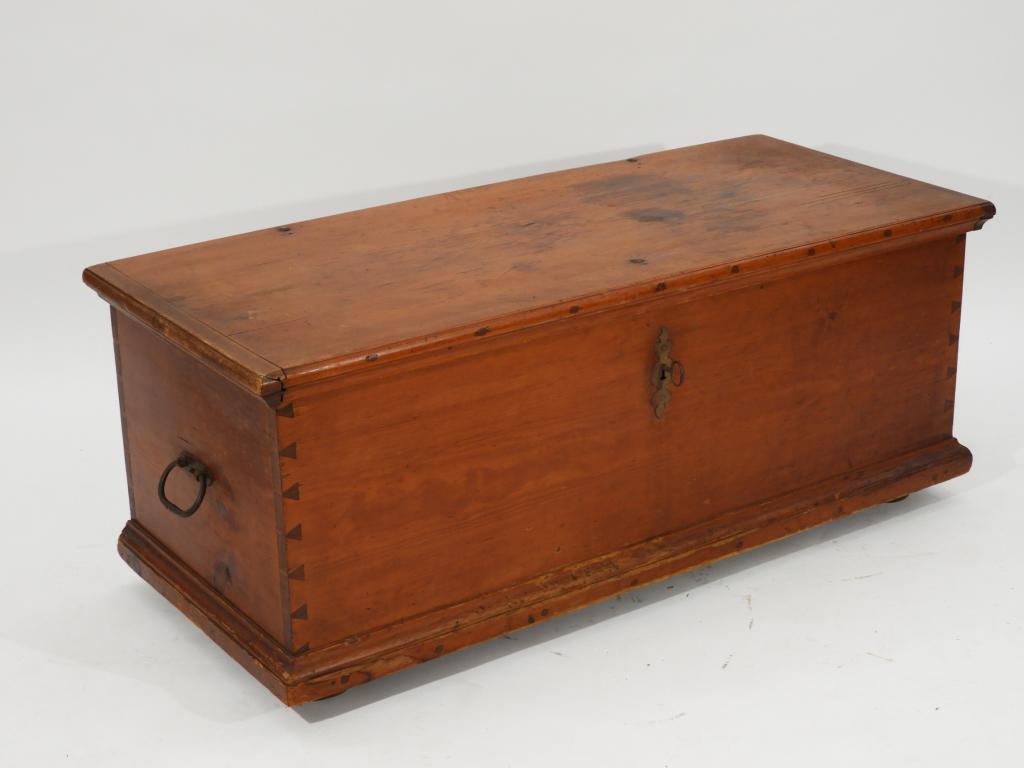 19C American Pine Dovetailed 6 Board Blanket Chest: ,United States,Early 19th Century Six board construction with dovetailed sides, strapped hinges, and iron handles on bun feet, original working lock and key.53" x 23" x 21 1/2" tall,,Pine