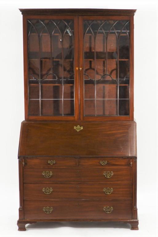 English George III Mahogany Secretary Desk: ,England,Early 19th Century Two door bookcase with architectural glass overlay and three interior shelves over a slant front with fitted interior over two small over three graduated drawers with stop 
