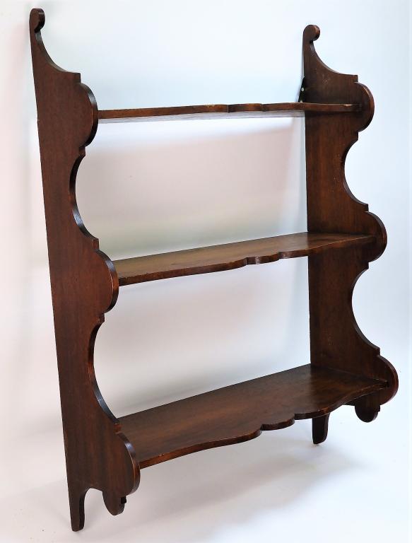 19C American Mahogany Hanging Wall Shelf: ,United States,19th Century Simple three tiered shelf with scrolled detailing to the edge of shelving and supports. 33 1/2" t x 24" w x 6 1/2" d,,Mahogany From the collection of a Westerly, Rhode Isla