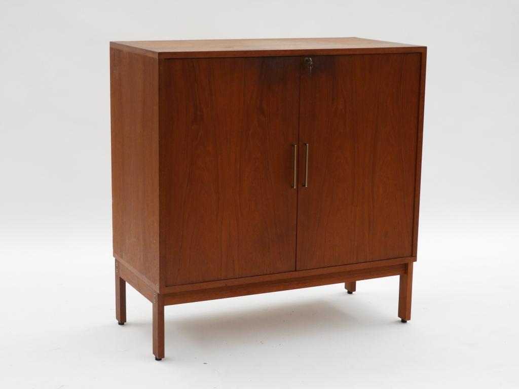 Danish Modern Teak Liquor Vice Serving Cabinet: ,Denmark,C.1960 Cabinet on stand with two locking doors interior with white Formica back and single adjustable shelf. 36" l x 18"d x 37 1/2"t,,Wood