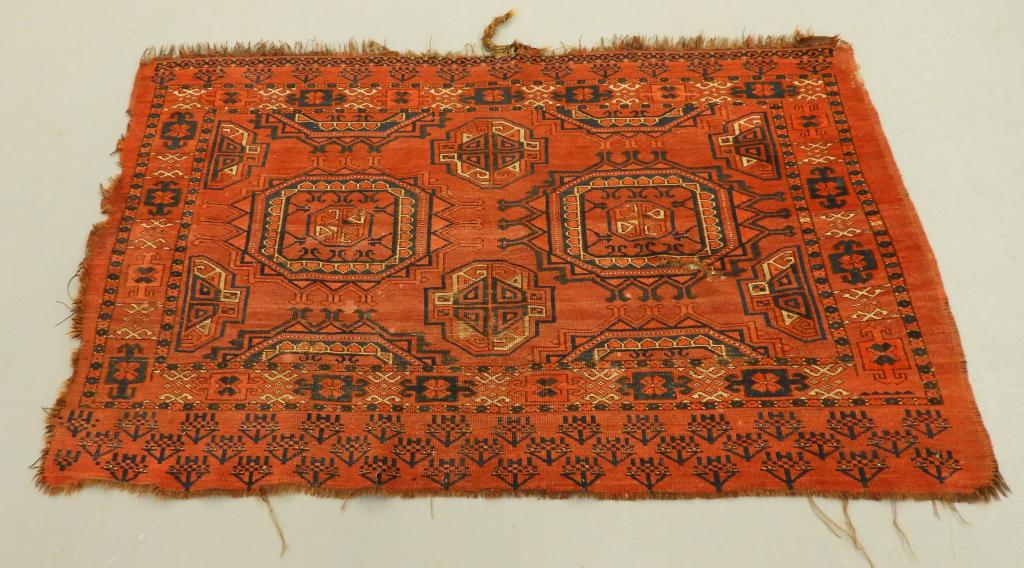 Antique Turkmen Tekke Bokhara Bagface Carpet: ,Afghanistan,C.1900 Bag remnant with rust red ground with black repeated medallions with geometric floral border.3'2" x 5'2",,Wool, cotton