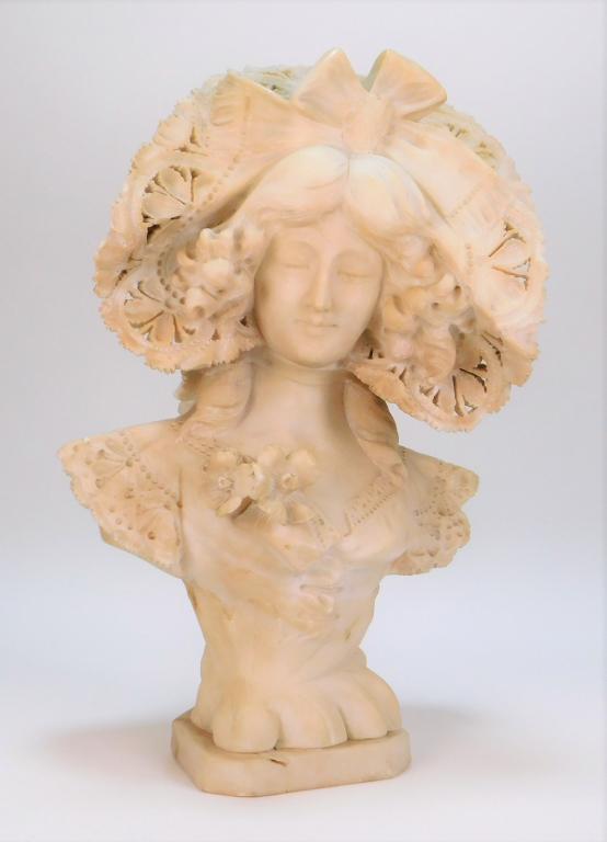 Adolfo Cipriani Young Women Alabaster Bust: Adolfo Cipriani Italy 1880-1930 Depicts a young woman with down turned gaze and voluptuous curls framed by a delicate lace bonnet. 17 3/8" t x 11 1/2" w x 8" d,,Alabaster Signed "A. Cipriani" on back