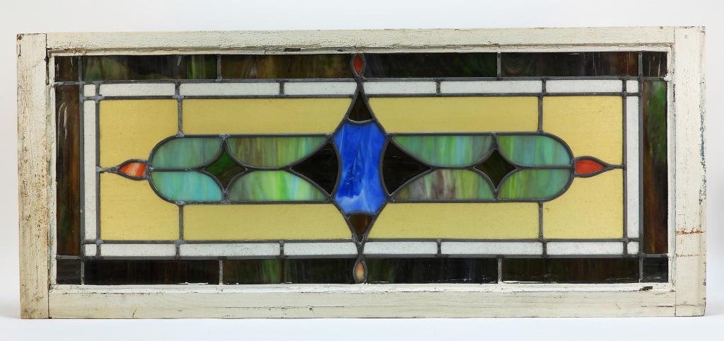American Leaded Stained Glass Window: United States 19th Century Central blue and amber glass star shaped cartouche flanked by two smaller amber stars surrounded by green, yellow, and slag glass borders. 39 1/2" x 16 5/8",,Glass, lead ,Fr