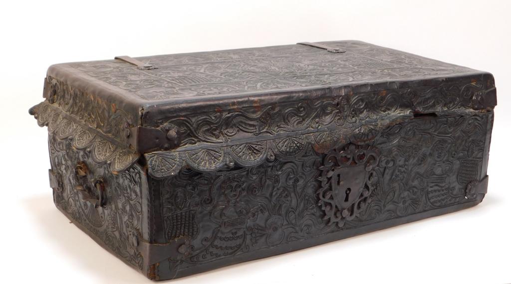 English Figural Tooled Leather Storage Trunk: England 19th Century Decorated with an all over botanical design with figural animals and people, a scalloped edge around the lid, and twisted metal handles opening to a single compartment. 8 1/2" t x