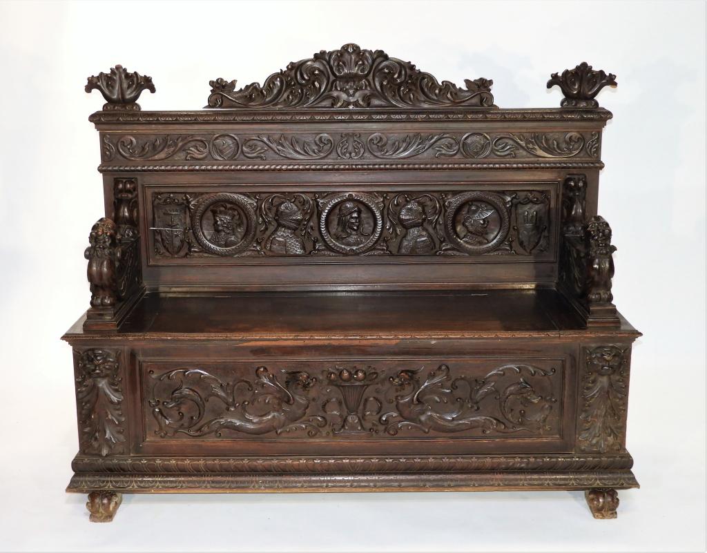 European Gothic Revival Carved Figural Hall Bench: Europe 19th Century Ornately carved crest over acanthus leaf band over military official portrait cartouches with gargoyles, lions, griffins, and mythical beasts throughout supported by scrolled feet.