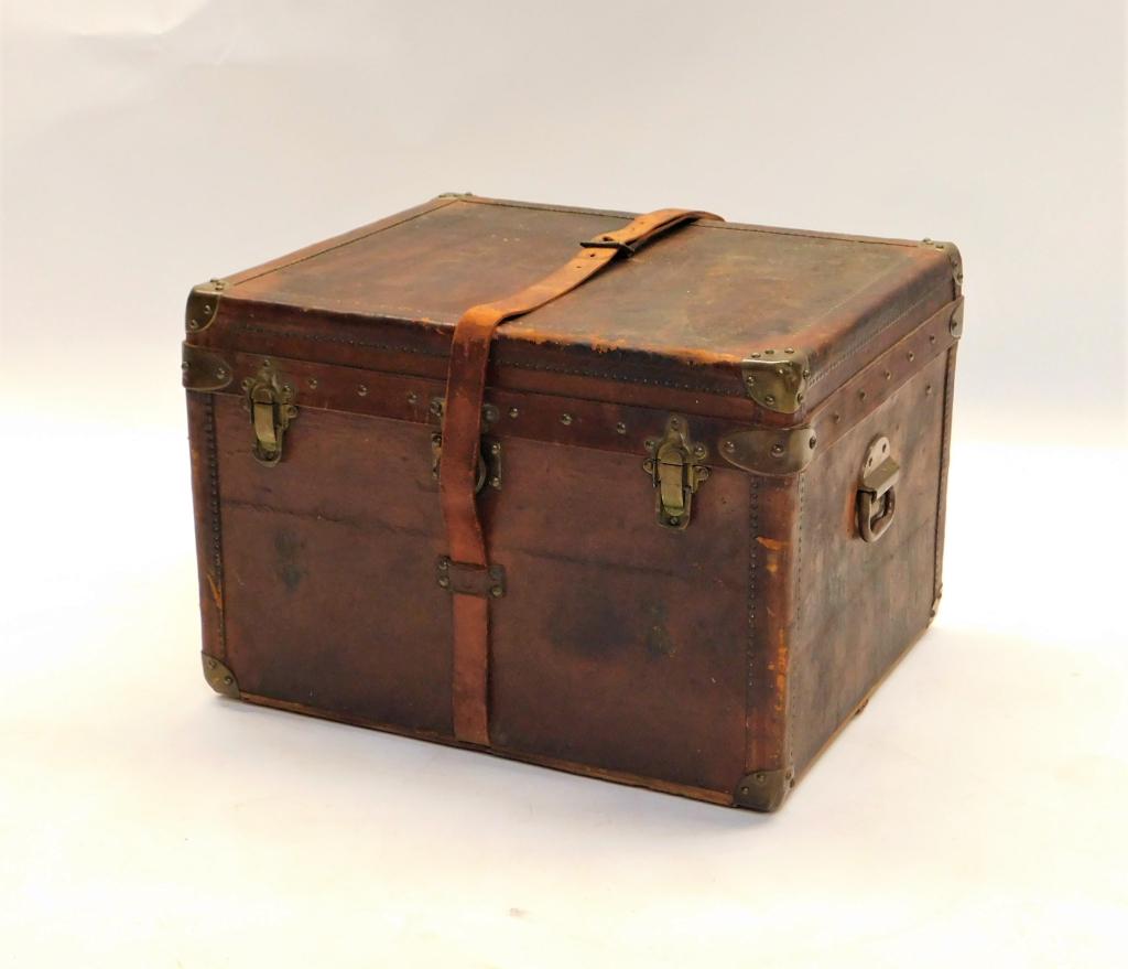 French E. Goyard Aine Leather Steamer Trunk: France Late19th- Early 20th Century Deep brown leather trunk with belt strap opening to tufted lid interior over basket inset over single compartment lined with cream canvas. 16 3/4" t x 24" w x 20" d