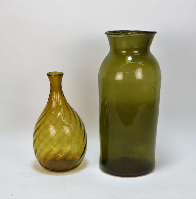 2PC American Hand Blown Glass Vessel Group: United States 19th C. Includes an amber glass bottle vase and a green glass pickle jar with flared rim. Smallest 10 1/4" x 4 3/4" dia.,Largest 14" x 5 3/4" dia.,Glass ,From the collection of a Warwick