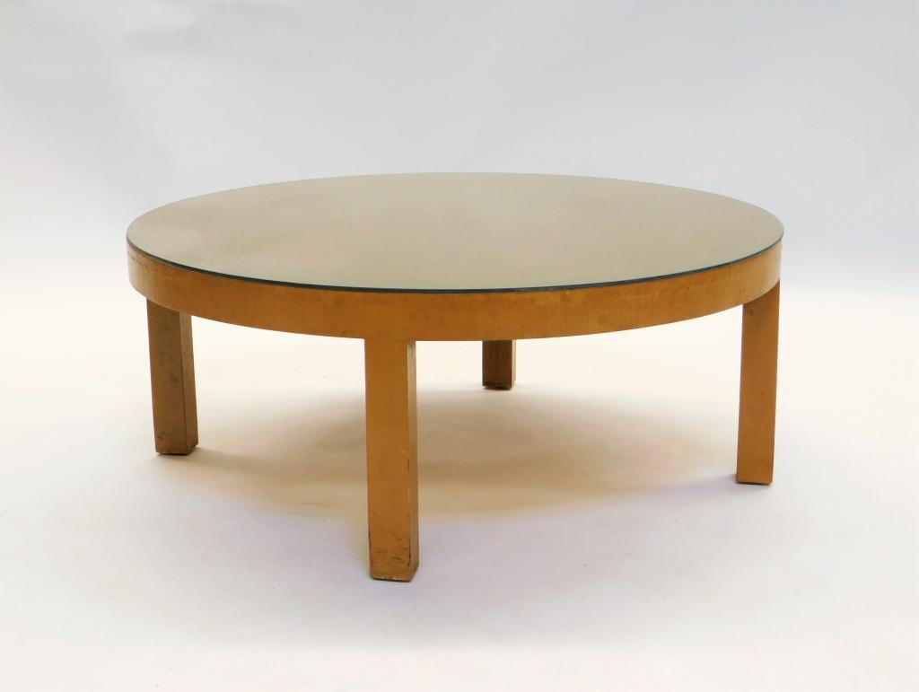 Widdicomb Glass Top Round Coffee Table: Michigan 20th Century Round glass top over round blonde wood top supported by four block legs. 15" t x 36" dia.,,Wood Marked "Modern Original Widdicomb" and "True Grand Rapids Cabinet Making Certified