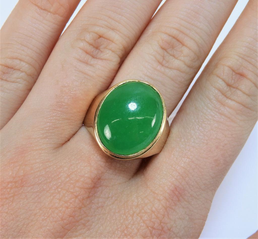 Chinese 14K Gold Apple Green Jadeite Ring: China 20th Century Oval polished apple green jadeite set in simple 14K gold band. Weight as seen 8.6 grams. Size 9 1/2,Stone 17mm x 14mm,14K gold, jadeite ,From the collection of a Manhattan, New York
