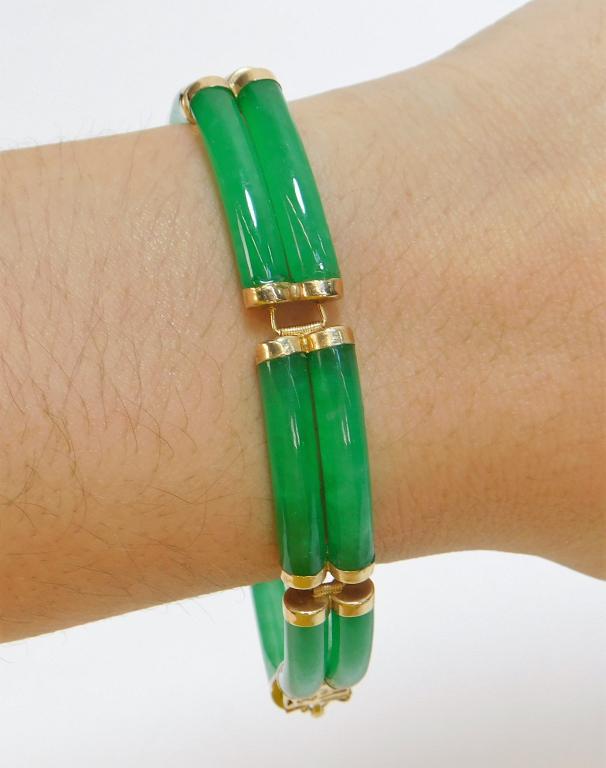 Lady's 14K Gold and Apple Green Jadeite Bracelet: China 20th Century Seven segment bracelet with exceptionally carved and polished apple green jadeite with 14K gold hardware. Weight as seen 24.4 grams. An exceptional quality and color of stone. Lengt