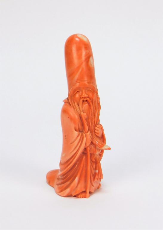 Exquisite Chinese Carved Coral Shoulao Statue: China Qing Dynasty Figural depiction of Shoulao, the God of Longevity, with his exaggeratedly long forehead and gentle smile carved from a blush colored coral branch. Exceptional details throughout, a