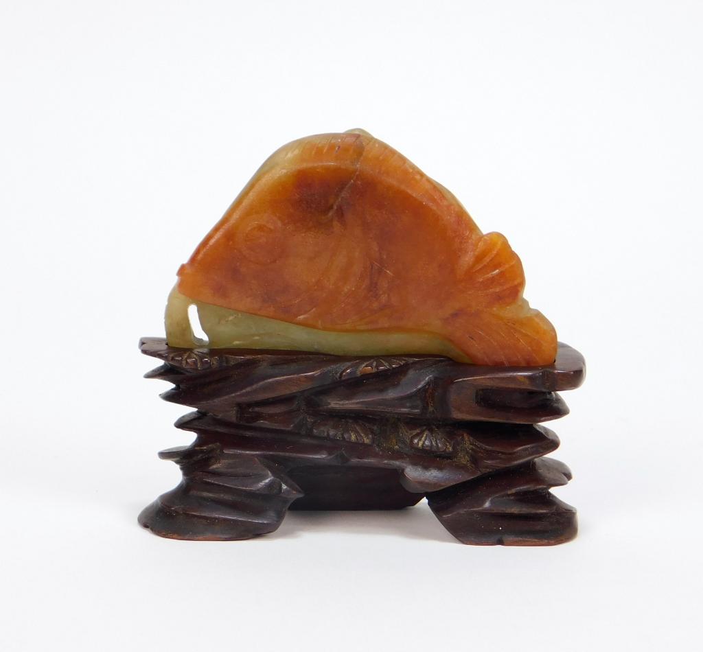 Chinese Celadon and Russet Carved Jade Sculpture: China Qing Dynasty Figural depiction utilizing a russet and celadon jade fragment to form a rich orange colored fish on one side and a celadon bat on the other. Jade 1 3/4" x 2 3/8",Overall 2 1/2" x 3