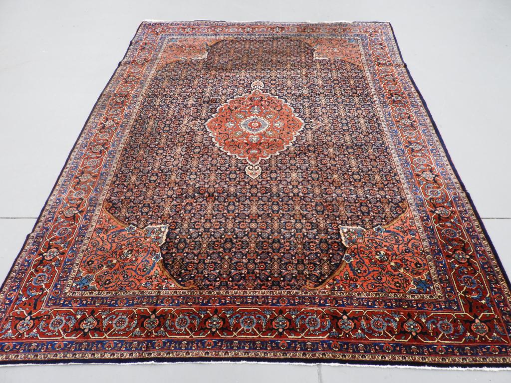 Circa 1910 Antique Persian Carpet Rug: Persia Circa 1910 Stylized central medallion over a intricately detailed navy field surrounded by stylized geometric borders. 11' 2" x 8' 6",,Wool ,From the collection of a Providence, Rhode Island ge