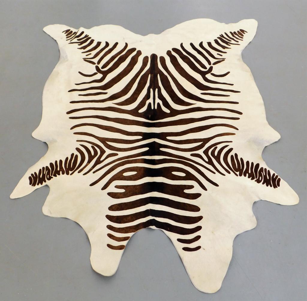 Zebra Print Cowhide Area Rug: California Late 20th Century Large area rug with deep brown dyed zebra stripes over cream colored fur. 92" x 75",,Cow hide Marked "Carlamb Sheepskin Seat Covers Sonoma, California" on underside.,From 