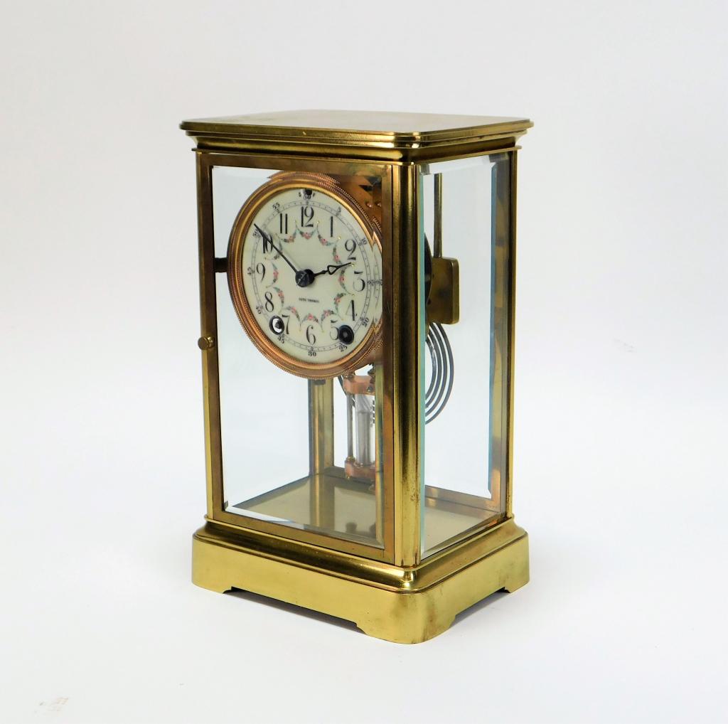 Seth Thomas Brass Regulator Mantle Clock: ,United States,Early 20th Century Rectangular brass and beveled glass panel case with swag and flower decorated clock face. Glass, brass,10 7/8" t x 6 5/8" w x 5 1/4" d, Marked "Seth Thomas" on clock