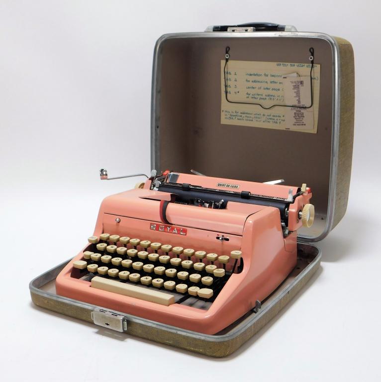 Pink Royal Quiet Deluxe Portable Typewriter: Connecticut,Circa 1940 Pink typewriter with white keys and olive green case. Metal,Typewriter 5 1/2" t x 12 3/4" w x 12" d.Case 13 3/4" t x 13" w x 6" d Marked "Royal" to front of typewriter From the