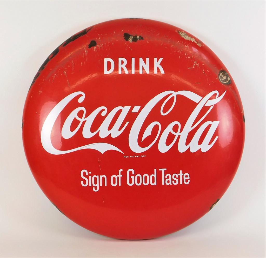 24" Coca Cola Porcelain Button Advertising Sign: United States,Circa 1960 Enameled round button advertisement sign reading "Drink Coca-Cola Sign of Good Taste" in white lettering over red. Metal, enamel,24" dia.. Marked "Reg. U. S. Pat Off." on fron