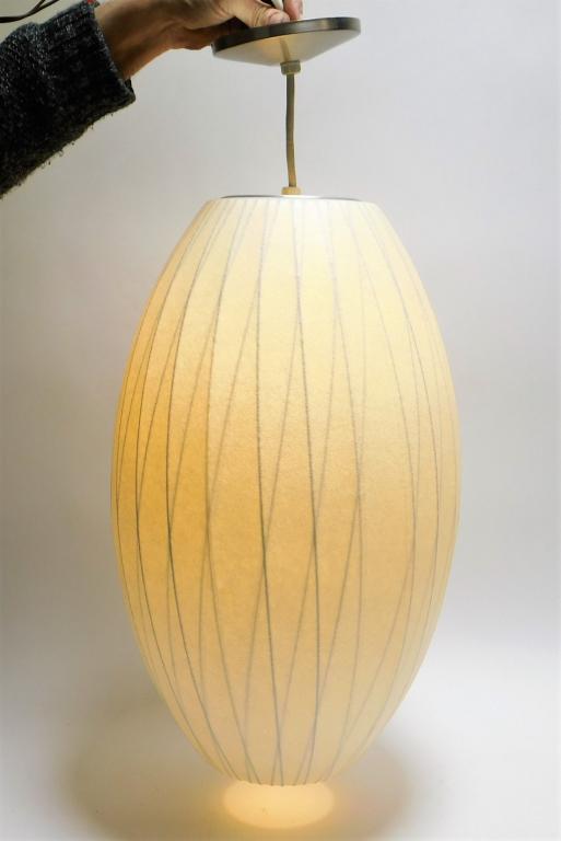 George Neslon for Modernica Bubble Ceiling Light: George Neslon Connecticut, New York, California,1908-1986 Cigar shaped pendant light with criss cross metal structure and white shade. Metal, textile,Shade approx. 21 1/2" x 12 1/2" dia..Approx. 33" x