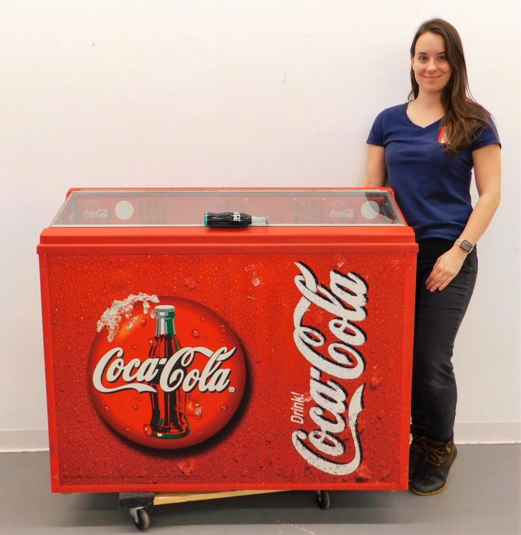 Coca Cola Advertisement Soda Cooler: United States,20th Century Refrigerated dispenser with all over Coca Cola design and glass bottle shaped handle. Metal, glass, plastic,39" t x 46" w x 16 1/2" d. Labeled "27429" inside machine. From t