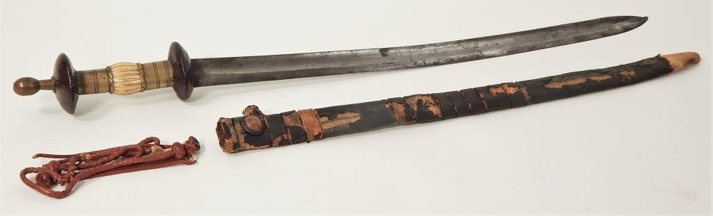 Middle Eastern or African Sword and Scabbard: Middle East,C. Late 19th to Early 20th century. Turned brass pommel with a leather-covered wood tope and bottom guard, grip has two brass ferules engraved with double lines, the central part of the gr