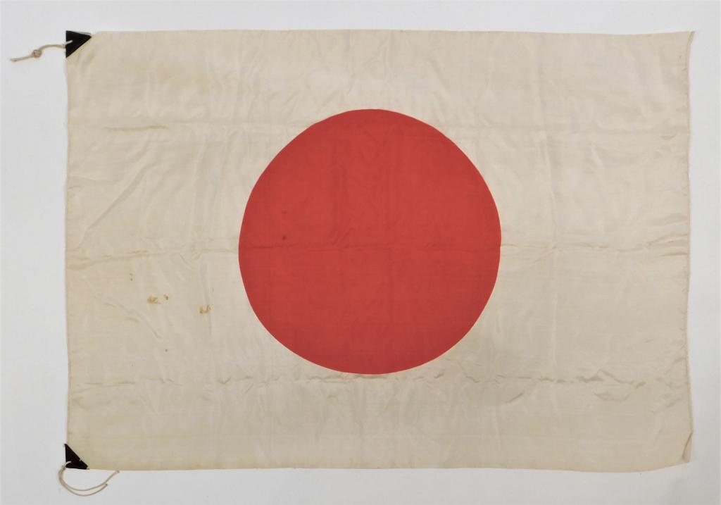Japanese Flag: Japan,C. 1930s-40s White silk "meatball" flag with leather tabs on each corner of the hoist. Ht. 27".Lg. 39" From the collection of a Warwick, Rhode Island gentleman.