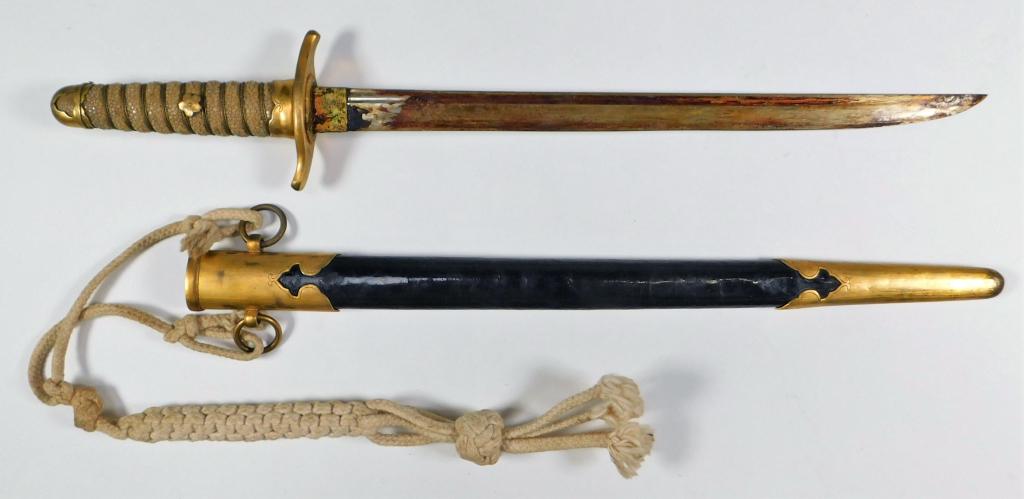 Japanese Naval dirk and Scabbard: Japan,C. early to mid-20th century gilt brass pommel cap, ferrule, and hand guard, wire-wrapped shagreen grip, steel blade, and a leather scabbard with gilt brass fittings. Blade lg. 12 3/4".Overall l