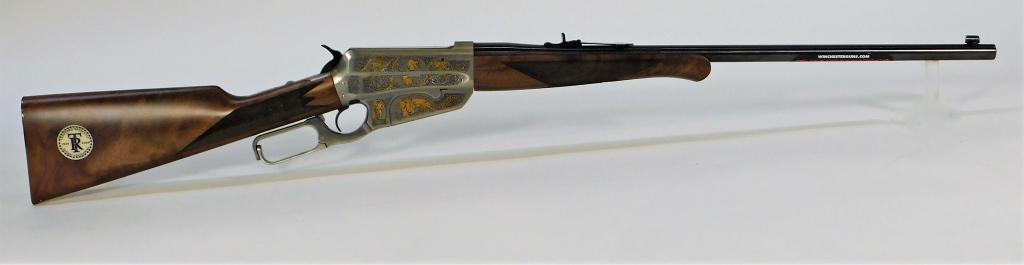 Winchester 1895 Teddy Roosevelt Lever-action Rifle: Japan, .405 Winchester caliber, serial number TR100H0709, high grade walnut stock with checkered wrist and forend, blued steel fittings, stainless receiver with gold and black foliate designs, animals