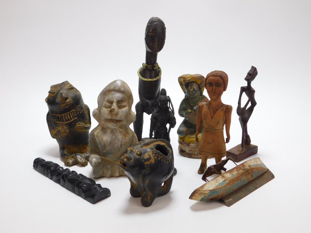 10PC Estate Tribal Effigy & Figure Group: Global,19th Century Includes a painted figure of Shiva, a toy boat, a seated carved stone seated figure, a carved wood woman in a white dress, African carved figure of a long limbed man, an African ca