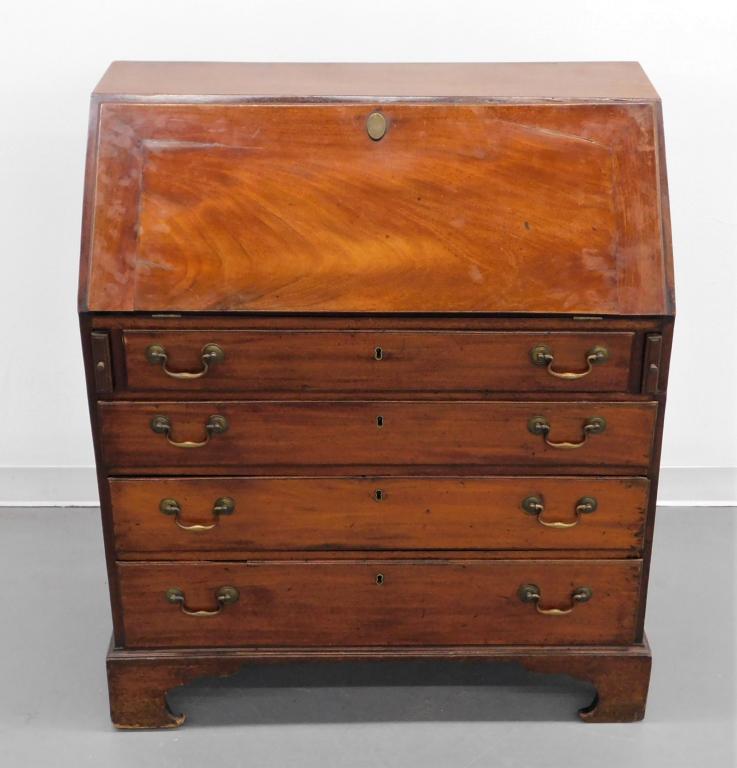 19C American Carved Mahogany Slant Front Desk: United States,19th Century Slant top opening to six drawers over seven compartments over six drawers supported by shapely feet. Mahogany,42" t x 37 1/4" w x 19 3/4" d, From the collection of a Manhatt