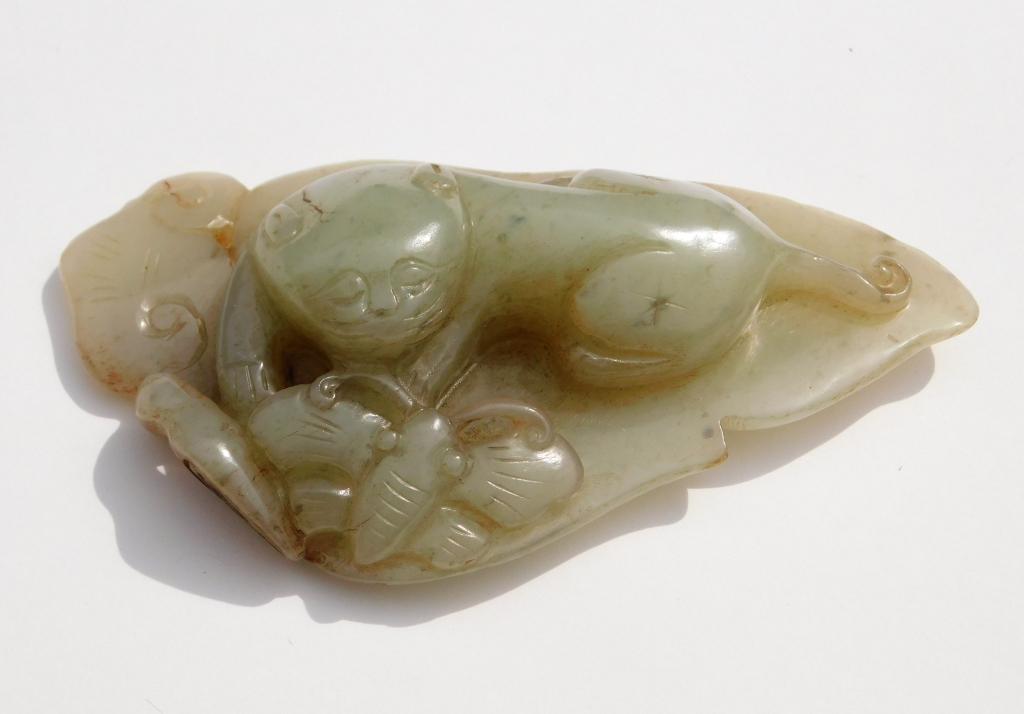 Chinese Qing Dynasty Carved Jade Ruyi: China,Qing Dynasty Depicts a lounging jaguar beside a butterfly on a leaf, carved from clam broth and russet jade. Jade,7/8" t x 4 3/8" w x 2 3/8" d, From the collection of a Waterloo, Canada gentlema