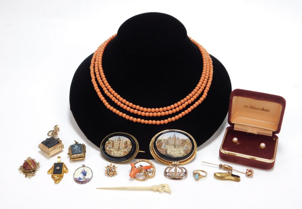 16PC Lady's Assorted Gold & Costume Jewelry: Continental,19th- 20th Century Includes a Virgin Mary enamel pendant, two architectural landscape brooches, a coral branch brooch, an tendril pendant with art glass center, a locket engraved with a un