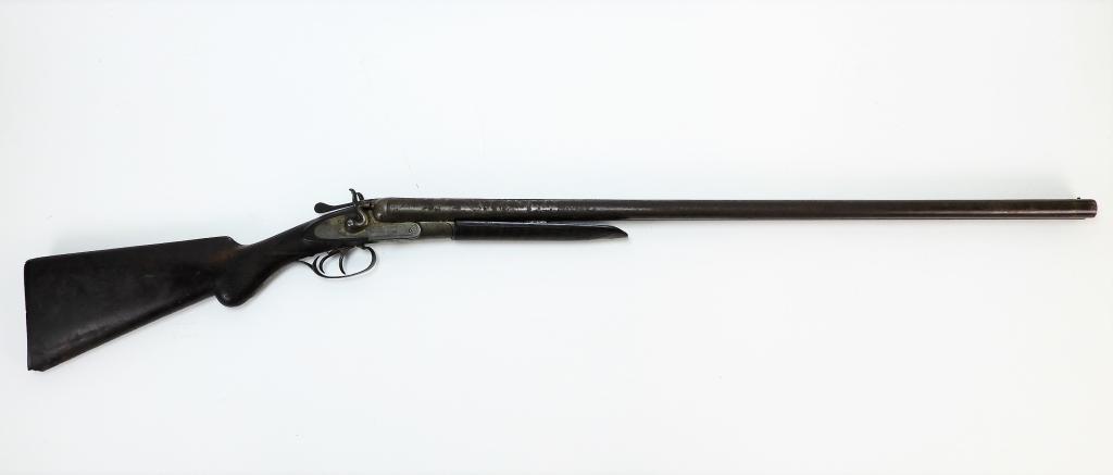 Antique Prize Machine Gun Double Barrel Shotgun: Belgium,Circa 1883 Features an attractive hard rubber butt plate depicting a hunting dog in the woods. Overall 45".Barrel 28".Wood, metal From the collection of a Barrington, Rhode Island estate. Mark