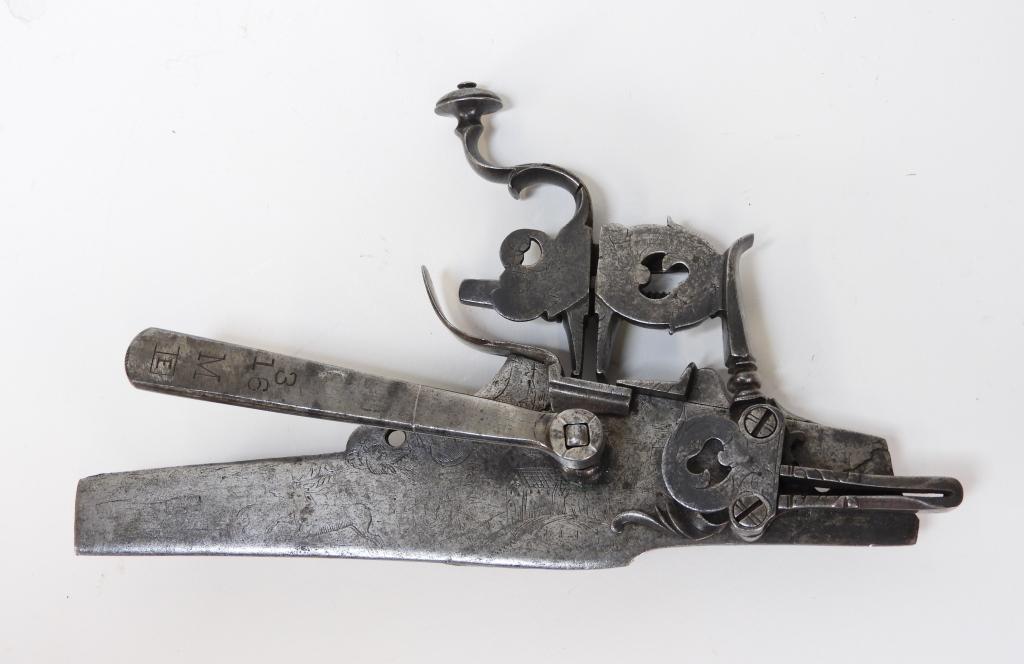 Northern European Wheellock Lock: C. 16th century Lock plate engraved with birds, animals, a house, church, and foliate designs, with a key to crank the wheel shaft. Overall lg. 8 7/8".Overall ht. 4 3/4"