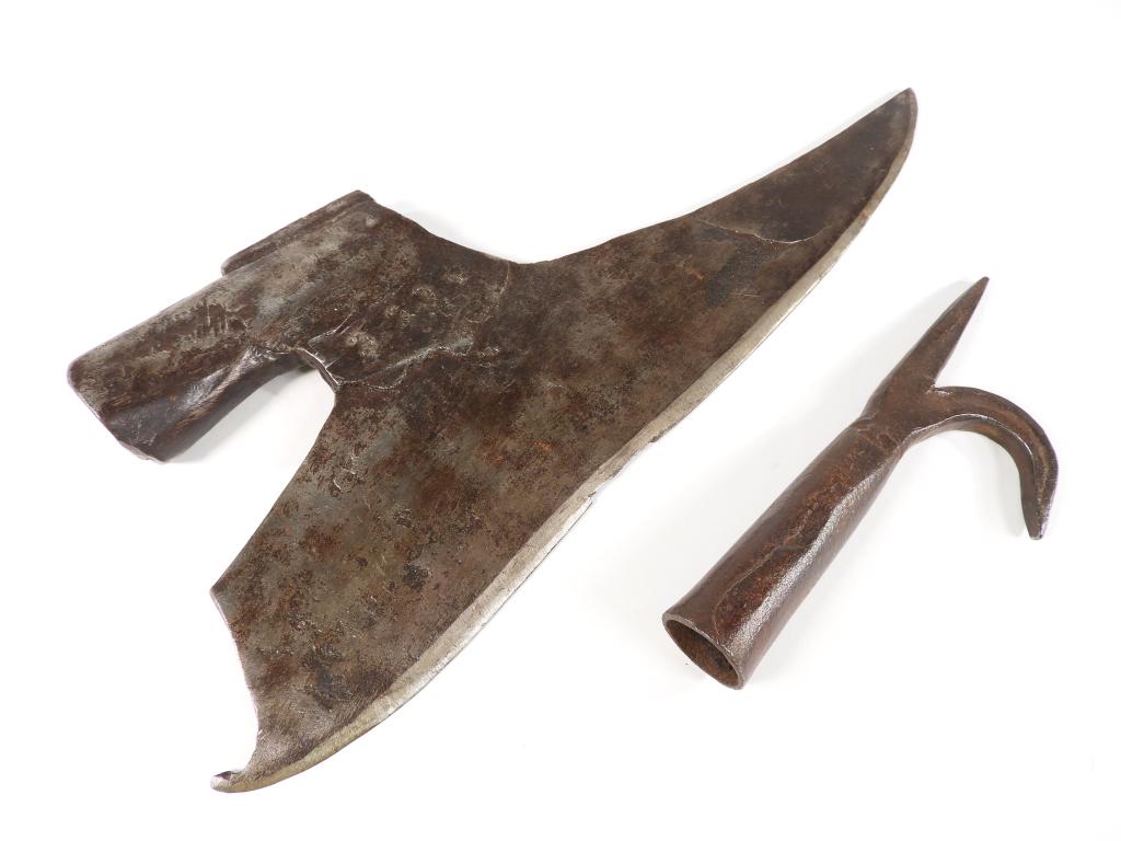 Two Iron Pole Arm Heads: Continental An iron forged axe head with a period welded cutting edge and patterned stamps on the right side of the attachment weld, and a pole spike with hook.