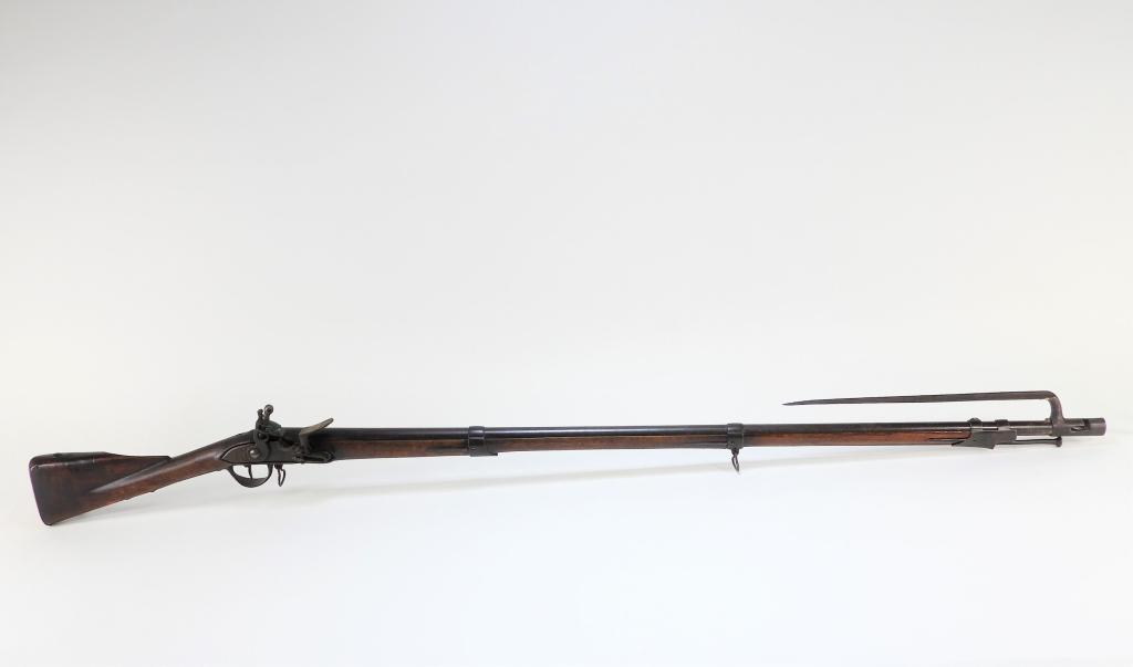 French Model 1763/66 Musket and Bayonet: France C. 1760s .72 bore, walnut stock marked with a "D" on the left side of the butt and shaved by the nose for cheek rest, iron fittings, lock marked with a "D" above"Charleville," with a bayonet lu