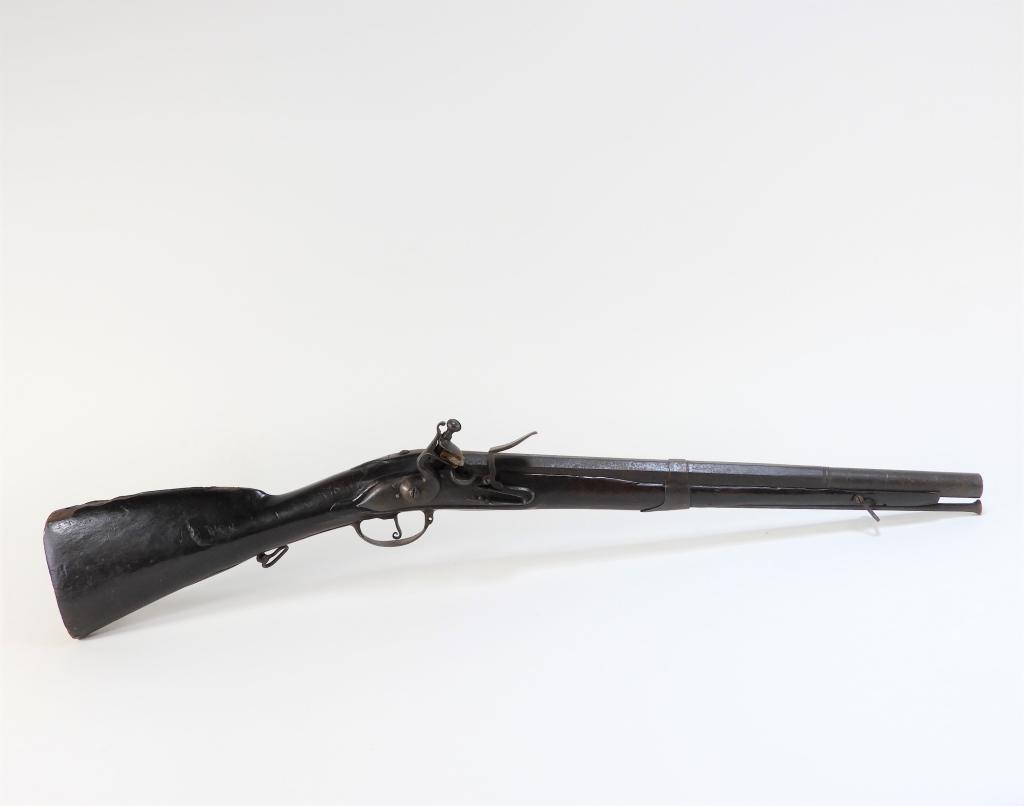 Cut-down Iron Mounted Musket: Netherlands C. early to mid-18th century .72 bore, walnut stock with iron fittings, lock has a small mark in a cartouche between the feather spring, octagonal to round barrel with an iron band, with s